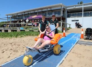 CQU Occupational Therapy students assisting in beach activities.