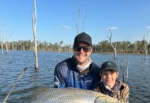 Matt Lindeman and his son Reeve Lindeman with Reeve's 101cm barra caught at Lake Monduran