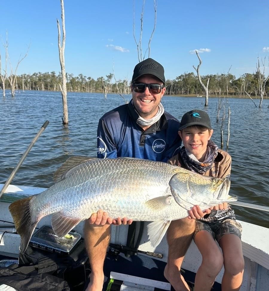 Matt Lindeman and his son Reeve Lindeman with Reeve's 101cm barra caught at Lake Monduran